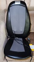Full front view of Homedics shiatsu massage seat with black synthetic leather and gray fabric panels.