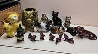 Full view of 8 animal figurines including cats, rabbit, donkey, and dog with pups