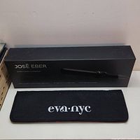 Jos Eber curling iron boxed and Eva NYC heat mat placed in front