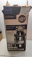 Original box of InSinkErator Badger 5 Quick Lock Food Waste Disposer showing front with product image and branding.
