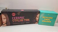 Photo shows the boxed ceramic styling tool and the boxed styling tool holder with branding and images of styled hair.