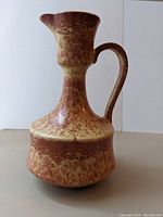Side view of the Italian ceramic jug vase showing its unique shape and mottled glaze
