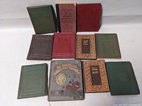 Overview of 11 antique miniature books in various colors and decorative covers, including The Longfellow Birthday Record.