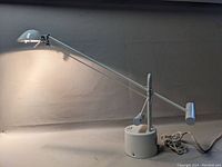 White metal cantilever desk lamp fully extended, showing shape and design