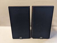 Front view of both speakers with grills attached and Celestion logo at bottom center