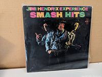 Front cover of Jimi Hendrix Experience Smash Hits vinyl LP with colorful album title and image of Jimi Hendrix