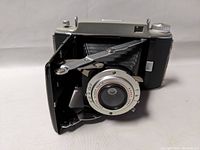Front angled view of Kodak Tourist II folding camera showing lens, shutter, and extended bellows.