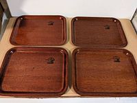 Four wooden trays from above showing size and shape, with Langva Denmark logos visible on top right of each tray