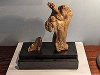 Front angled view of the wood sculpture showing both mother and child figures with base