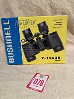 Photo of the original yellow and blue Bushnell PowerView box showing an image of the binoculars and product specifications.