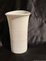 Front view of the white ceramic Kaiser vase showing textured pattern and flared top.