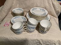 Group shot showing stacks of dinner, luncheon and dessert plates with cups and saucers in front