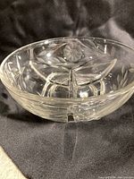 Side view of the clear glass divided dish showing three compartments and etched cornflower pattern.