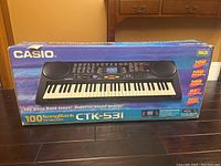Photo of Casio CTK-531 keyboard boxed with product branding and features highlighted on box.