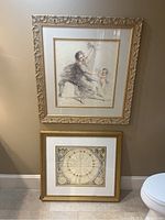 Two framed art prints on the floor against a wall, showing relative scale and overall appearance of each framed piece