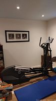 Side view of elliptical trainer in basement room