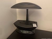 Full view of AeroGarden indoor grow light showing the light panel, planting pods area, and base with control panel.