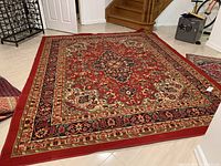 Full view of rug on floor showing overall pattern and size