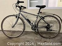 Side view of silver Rocky Mountain road bike with 18-inch frame, showing the full profile and tires.