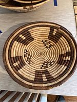 Top view of the woven bowl showing natural and dark brown concentric circular patterns