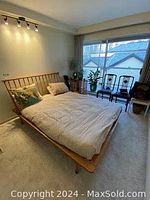 Full assembled bed frame with foam mattress and fitted sheet, headboard and footboard visible