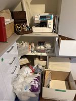 Corner shelf with sewing machine, plastic bins and woven baskets