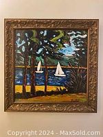 Framed oil painting depicting sailboats on a lake with trees in the foreground
