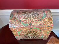 Front view of hand painted wood chest showing geometric star pattern and dome top
