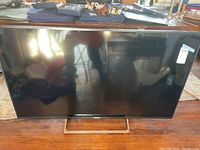 Front full view of the Sony TV showing the screen, bezel, and metal stand.