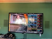 Front view of the Samsung TV showing cryptocurrency financial news channel on screen.