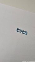 Two rectangular cut sky blue topaz stones on a white background, showing color and clarity under natural lighting.
