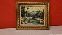 Full view of framed mountain scene oil painting