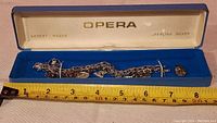 Full view of the bracelet in its Opera branded box showing overall length and presentation.