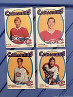 Front view of four 1971-72 OPC Montreal Canadiens hockey cards showing players Dale Hoganson, Claude LaRose, Jacques Laperierre, Serge Savard in red jerseys.