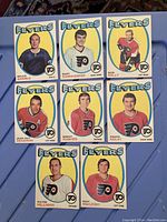 Front side showing player portraits and team Flyers logo with blue and yellow background frame on each Hockey card.