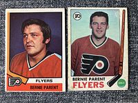 Fronts of two Bernie Parent hockey cards showing condition issues including crease and discoloration