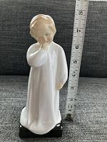 Front view of Royal Doulton Darling HN1319 figurine with measuring tape showing approx. 8 inch height.