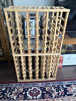 Front view of wooden wine rack showing its bottle holding structure and capacity.