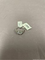 Photo of the 925 sterling silver ring with size tag showing size 7 and 925 mark.