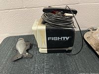 Black FishTV monitor and fish-shaped camera assembly with cable