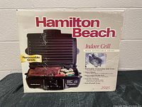 Photo of the original product box showing the Hamilton Beach Indoor Grill with removable cooking grids and image of grill with steaks and vegetables.