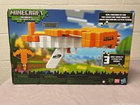 Front view of the Minecraft Nerf Pillager's Blaster box showing the crossbow, brand, and features.