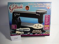 Full boxed kit showing Cathy Mitchell's Gem-Magic crafting tool with black handheld unit and included accessories.