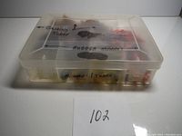 Closed plastic tackle box with labeling on lid and front side describing contents (Guiding Tubes, Rubber Minnows, Minnows/Tubes).