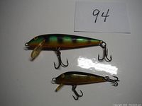 Photo of two perch colored Rapala Countdown fishing lures, one large and one small, displayed side by side showing top and side views with attached treble hooks