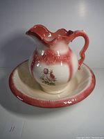 Full view of vintage ceramic jug and washbowl with floral design and gradient coloring.