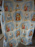 Full view of the vintage comforter displaying multiple 1982 E.T. The Extra-Terrestrial cartoon-styled scenes against a light blue background.