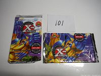 Two unopened 1996 Fleer X-Men trading card packs featuring Wolverine artwork and promotional text about a $451,000 sweepstakes.