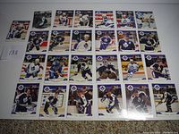 Full view of 34 Toronto Maple Leafs hockey cards spread on white background, showing front card faces with player photos in team uniforms.
