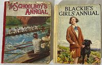 Photo showing the front covers of two annuals, The Schoolboy's Annual and Blackie's Girls Annual, both hardcover with cloth spines.